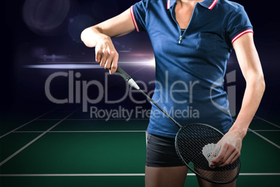 Composite image of badminton player holding a racket ready to se