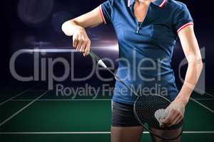 Composite image of badminton player holding a racket ready to se