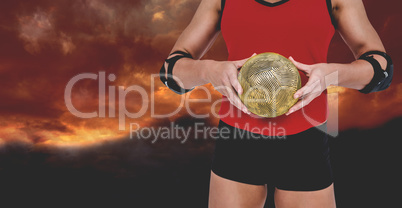 Composite image of female athlete with elbow pad holding handbal