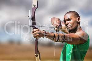 Composite image of close up view of man practicing archery