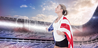 Female athlete with american flag on her shoulders