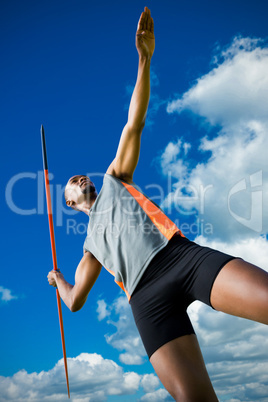 Composite image of low angle view of athletic man preparing his