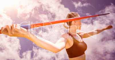 Composite image of close up of sportswoman hand holding a javeli