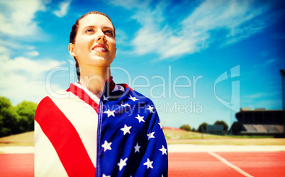 Composite image of low angle view of sporty woman holding a amer