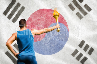 Composite image of rear view of athletic man holding the olympic