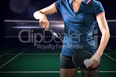 Composite image of badminton player holding a racket ready to se