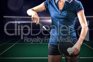 Composite image of badminton player holding a racket ready to se