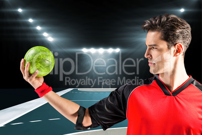 Composite image of confident athlete man holding a ball