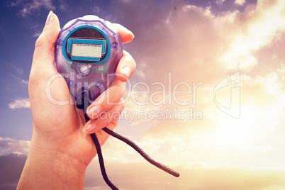 Close up of woman is holding a stopwatch on a white background a