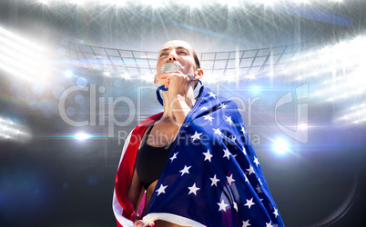 Composite image of sporty woman with american flag kissing her m