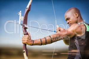 Composite image of side view of sportsman practising archery