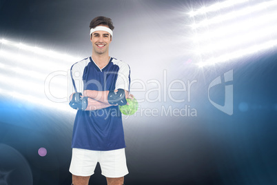 Composite image of sportsman standing with ball on white backgro