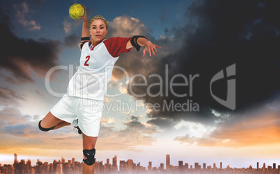 Composite image of sportswoman throwing a ball