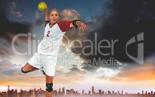 Composite image of sportswoman throwing a ball