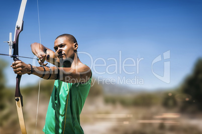 Composite image of facing view of man practicing archery against