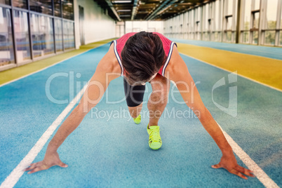 Composite image of male athlete in ready to run position
