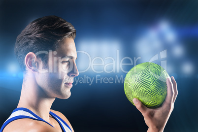 Composite image of confident athlete man holding a ball