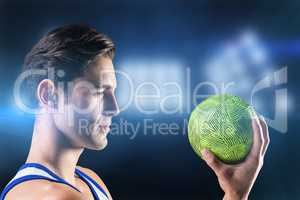 Composite image of confident athlete man holding a ball