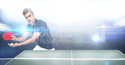 Confident male athlete playing table tennis