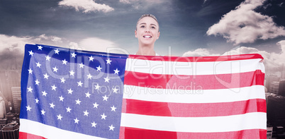 Composite image of female athlete holding american flag