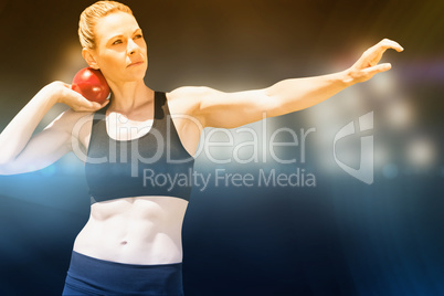 Composite image of front view of sportswoman practising shot put