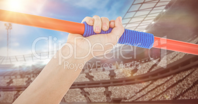 Composite image of close up of a hand holding a javelin