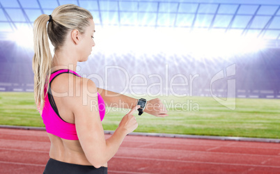 Composite image of female athlete using her smart watch