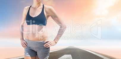 Composite image of sportswoman is posing and smiling
