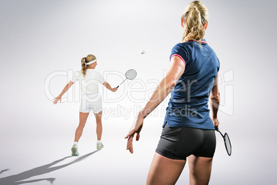 Composite image of badminton players playing badminton Composite image of badminton players playing badminton
