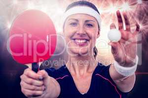 Composite image of female athlete holding table tennis paddle an