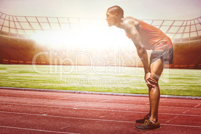 Profile view of sportsman posing his hands on knee