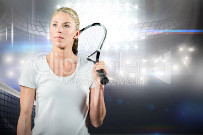 Female tennis player looking away with her racket
