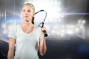 Female tennis player looking away with her racket
