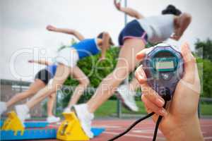 Composite image of woman is holding a stopwatch