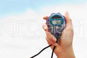 Close up of a hand holding a timer on a white background against