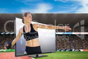 Composite image of concentrated sportswoman practising discus th