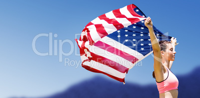 Profile view of sportswoman raising an american flag