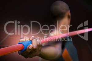 Composite image of close up on sportsman hand holding a javelin