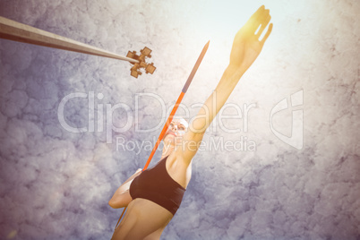 Composite image of sporty woman preparing her javelin throw