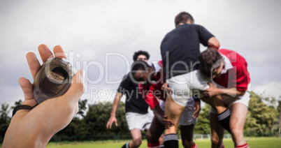 Composite image of coach is holding a stopwatch