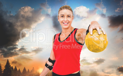 Composite image of female athlete with elbow pad holding handbal