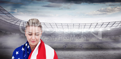 Female athlete with american flag on her shoulders