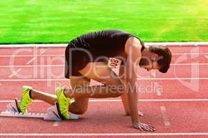 Composite image of sportsman waiting on the starting line