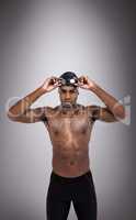 Composite image of swimmer holding goggles