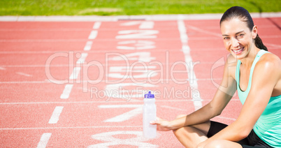 Portrait of happy sportswoman is sitting with a flask