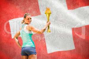Composite image of woman posing with trophy