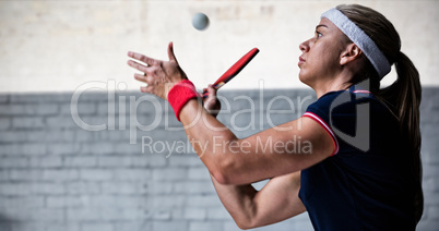 Composite image of female athlete playing ping pong