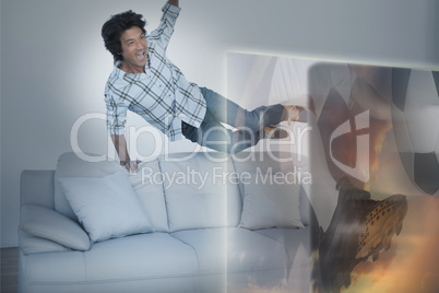Composite image of excited man are watching sport on television