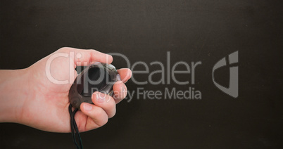 Close up of coach is holding a stopwatch  against blackboard