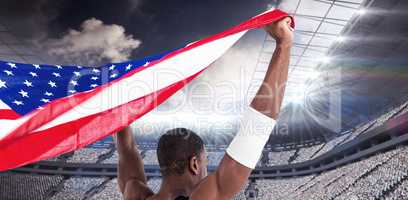 Composite image of athlete holding american flag